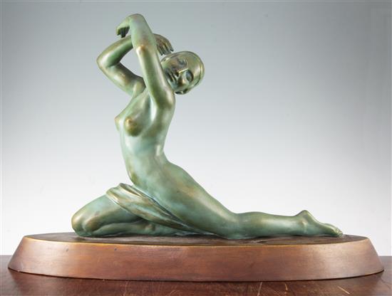 A French Art Deco painted terracotta model of a female nude dancer, 28in.